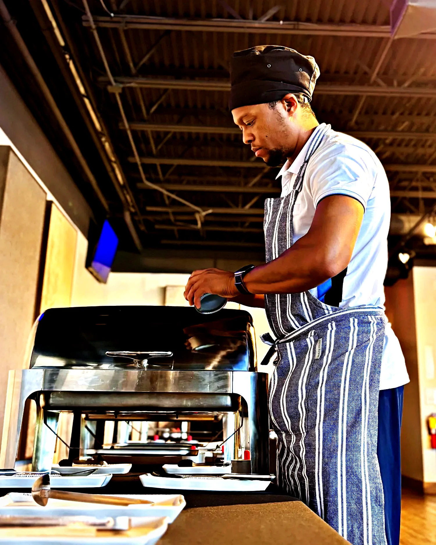 Chef Lee Norris setting a chafing line before service