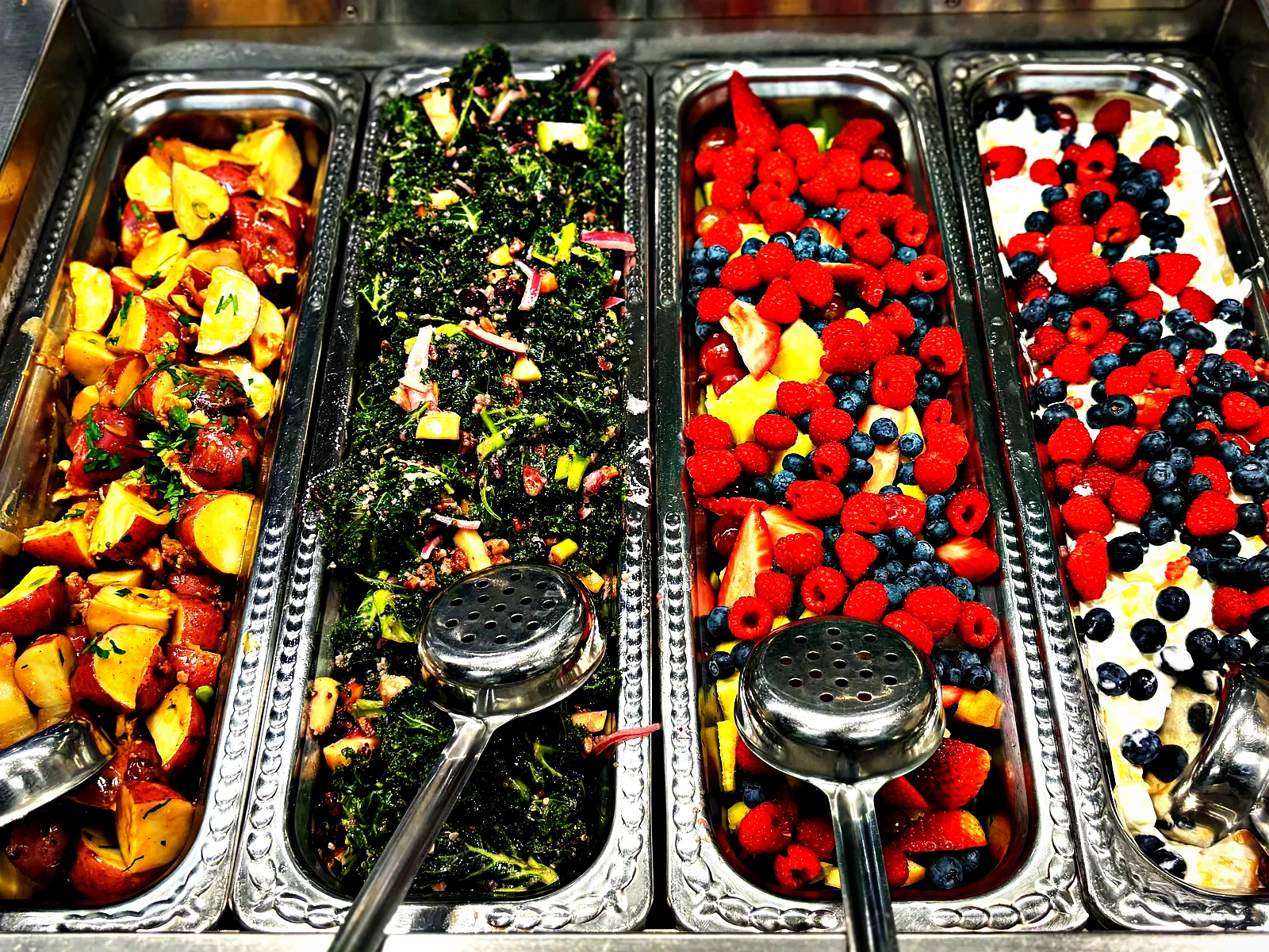 Cold line of potato salad, kale salad and fresh berries