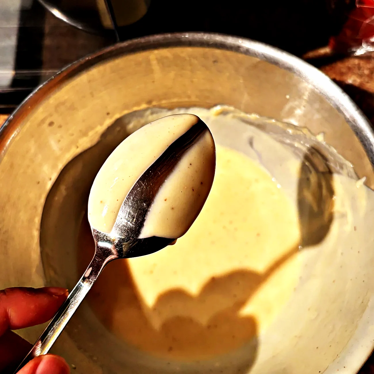 Cream sauce coating the back of a spoon