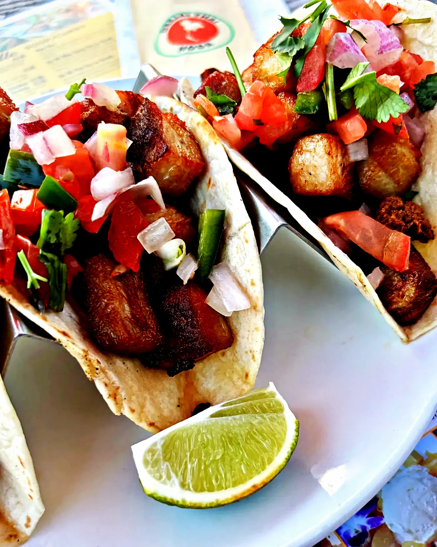 Crispy pork belly tacos with pico de gallo and lime